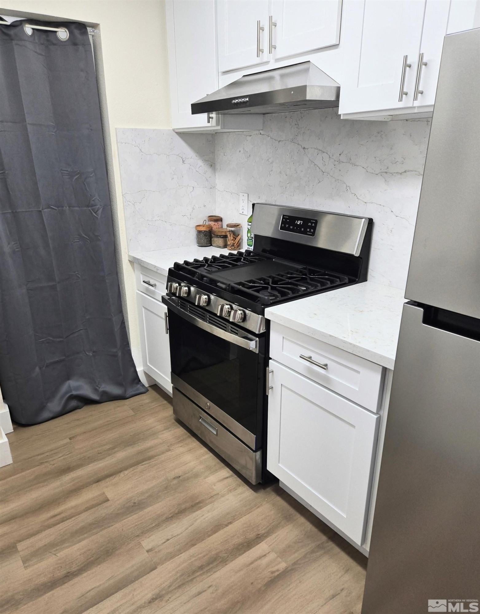 100 Bisset Court, Unit B Reno, NV 89503 - Photo 9 of 31 a stove top oven sitting inside of a kitchen