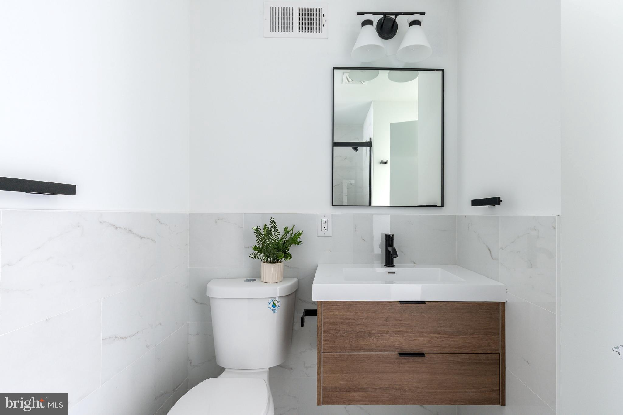 2925 Master Street Philadelphia, PA 19121 - Photo 22 of 41 a bathroom with a sink toilet and mirror
