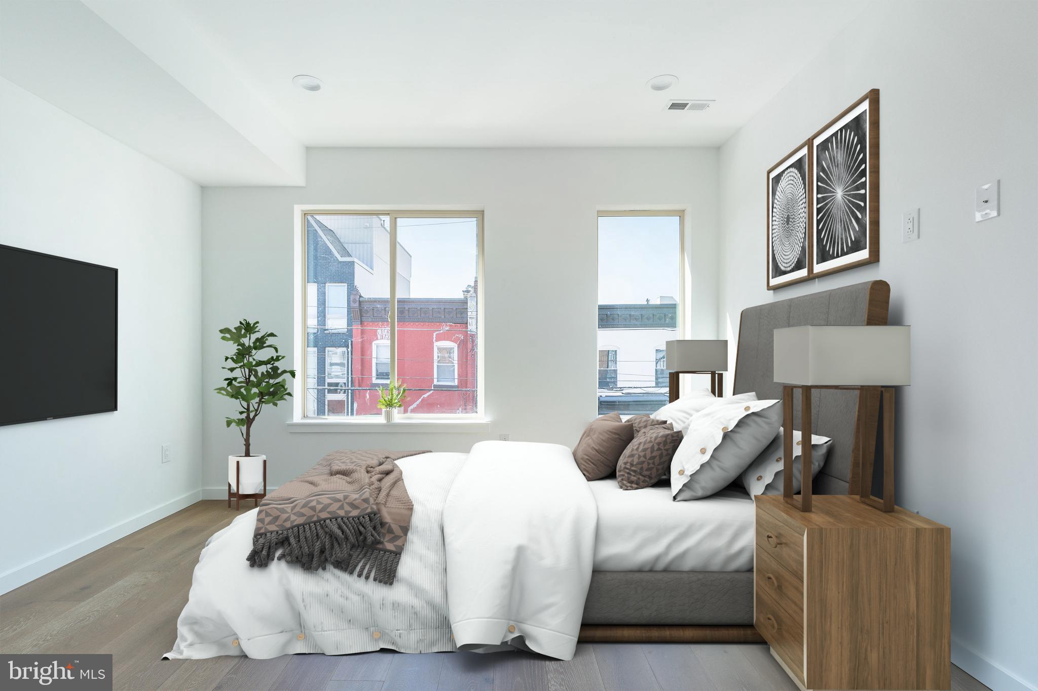 2925 Master Street Philadelphia, PA 19121 - Photo 26 of 41 a bedroom with a bed and a flat screen television