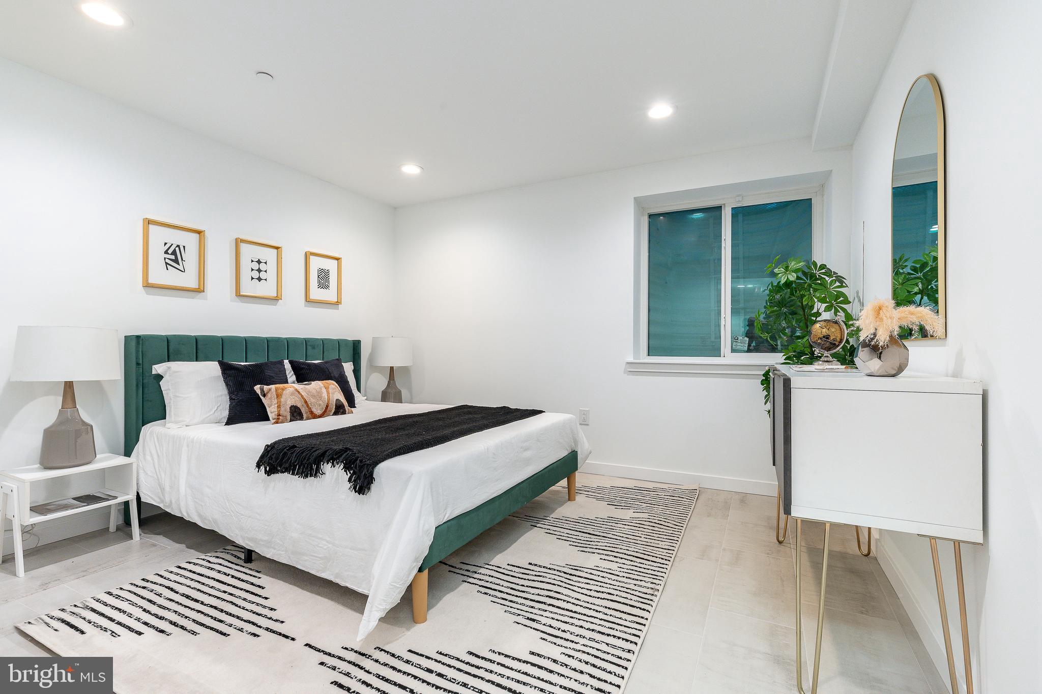 2925 Master Street Philadelphia, PA 19121 - Photo 29 of 41 a bedroom with a large bed and a potted plant