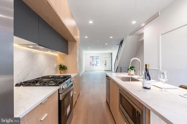 a kitchen with sink stove and refrigerator