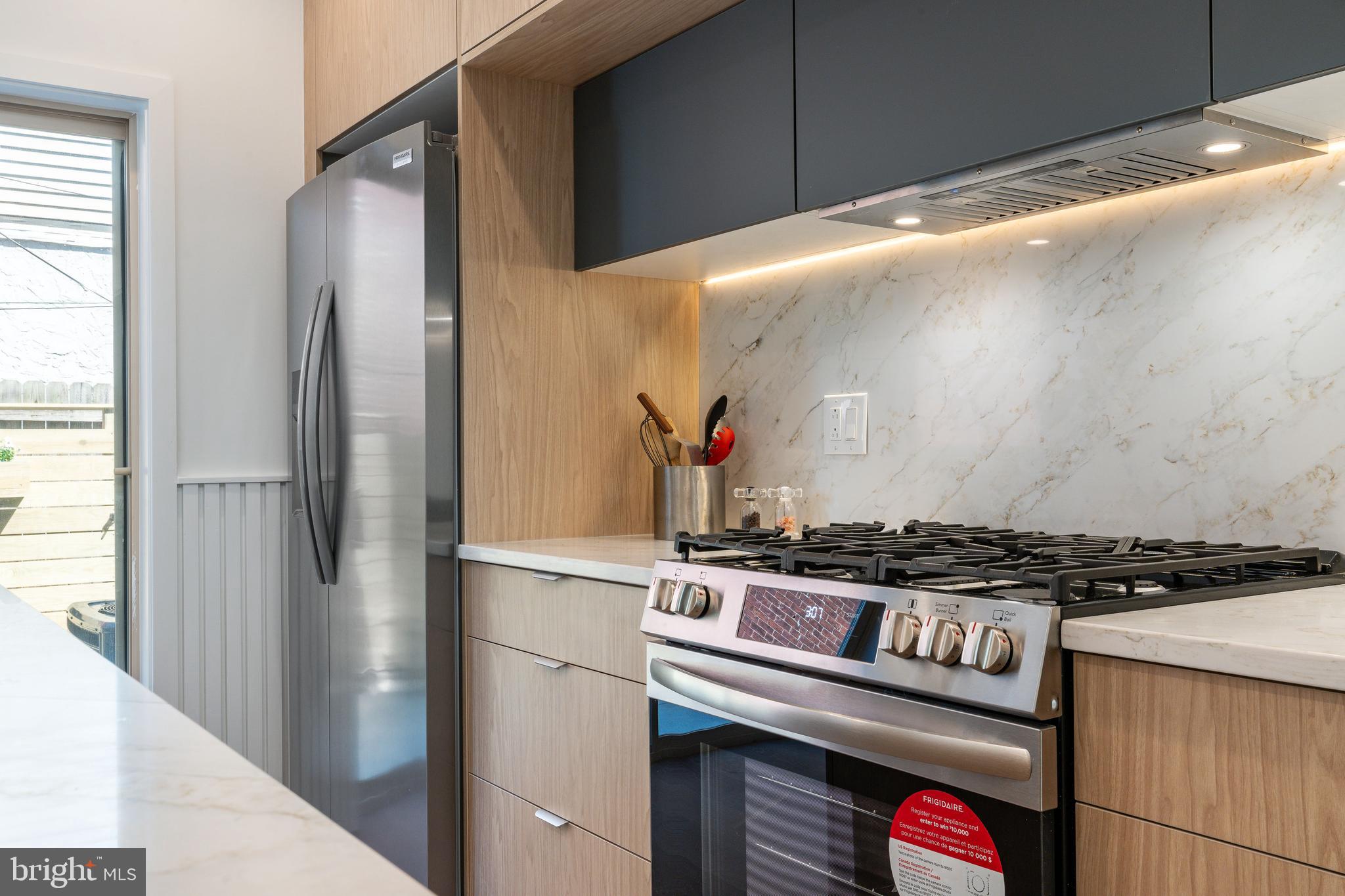 2925 Master Street Philadelphia, PA 19121 - Photo 5 of 41 a kitchen with stainless steel appliances granite countertop a refrigerator and a stove