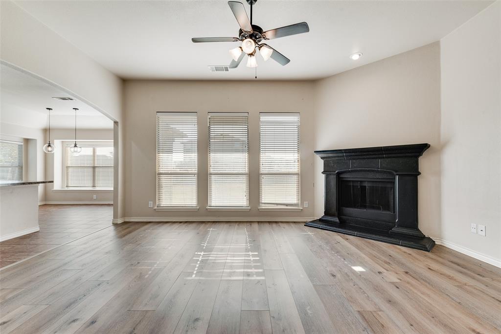 103 Rambling Way Forney, TX 75126 - Photo 12 of 32 a view of empty room with wooden floor and fireplace