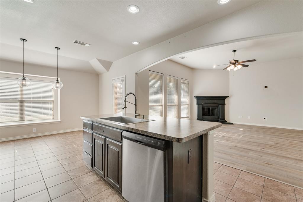 103 Rambling Way Forney, TX 75126 - Photo 32 of 32 a kitchen with stainless steel appliances granite countertop a sink and a stove