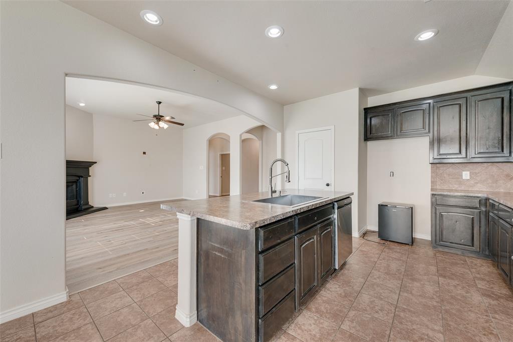 103 Rambling Way Forney, TX 75126 - Photo 14 of 32 a kitchen with a stove and a sink