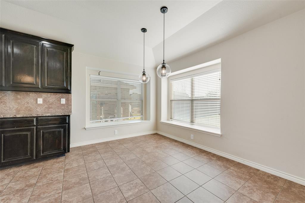 103 Rambling Way Forney, TX 75126 - Photo 17 of 32 a view of an empty room with a kitchen
