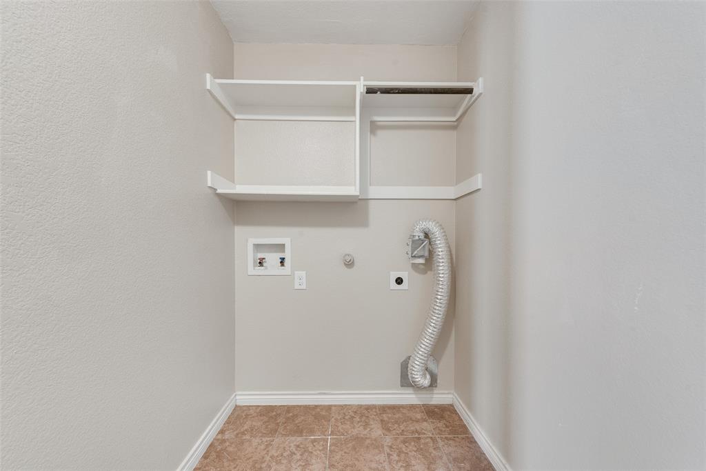 103 Rambling Way Forney, TX 75126 - Photo 19 of 32 a view of walk in closet with empty racks