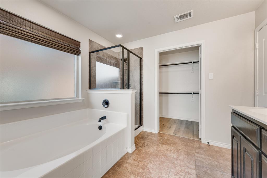 103 Rambling Way Forney, TX 75126 - Photo 24 of 32 a bathroom with a bathtub and a shower