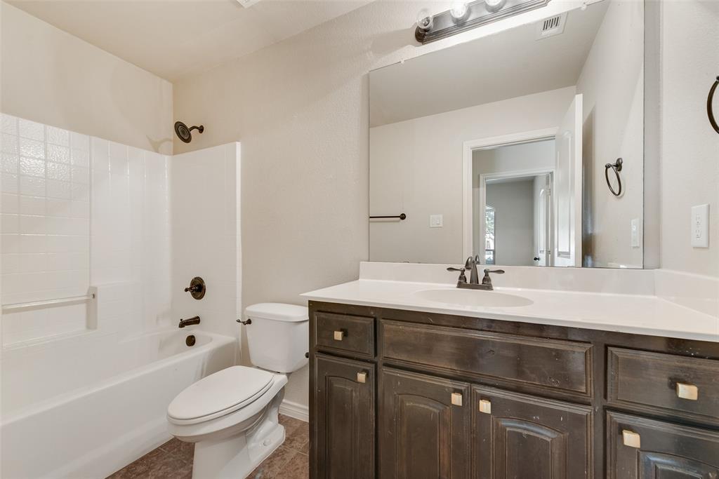 103 Rambling Way Forney, TX 75126 - Photo 27 of 32 a bathroom with a sink a toilet and shower