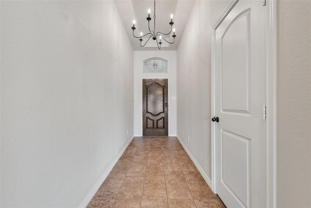 103 Rambling Way Forney, TX 75126 - Photo 7 of 32 a view of a hallway with a chandelier