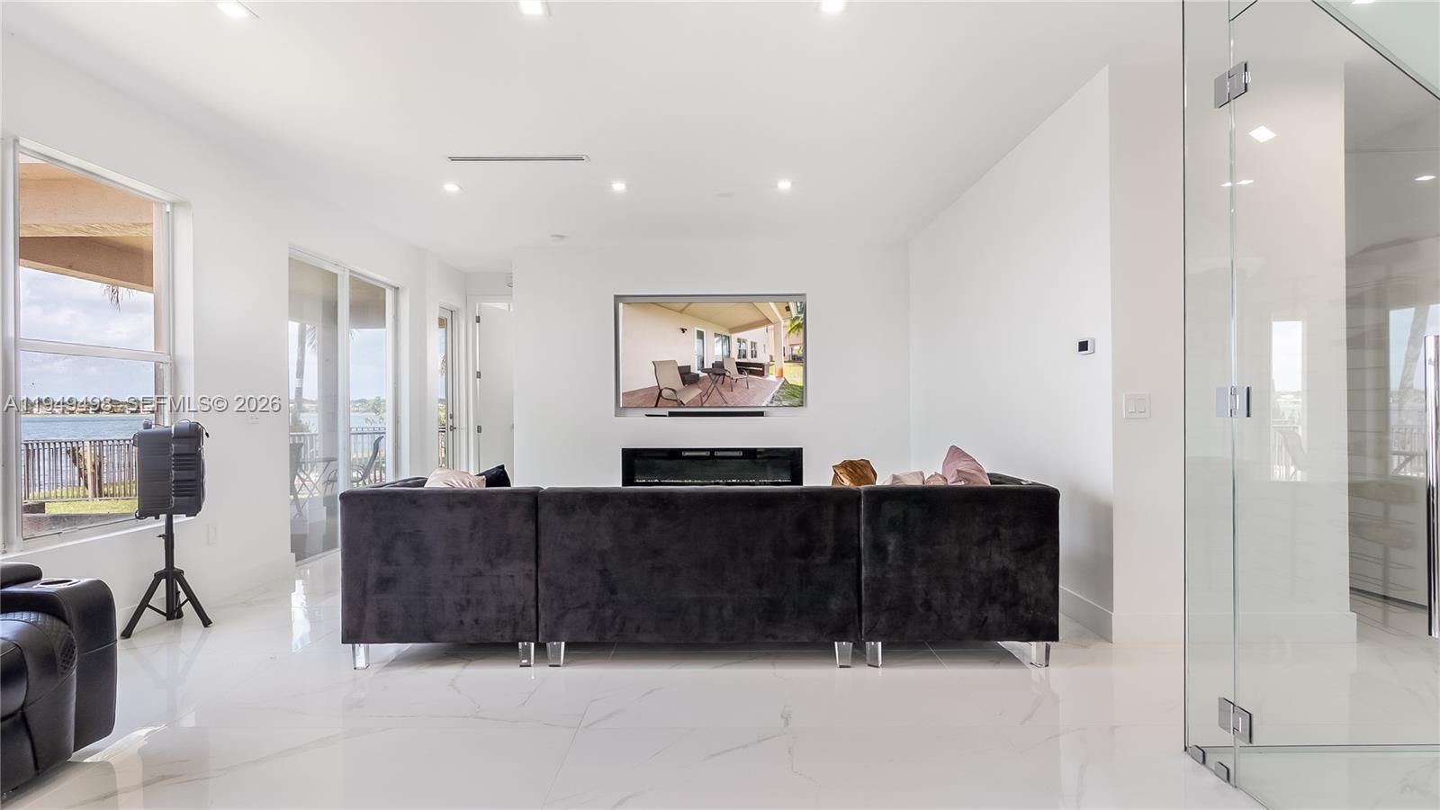 17739 Southwest 54th Street Miramar, FL 33029 - Photo 15 of 47 a living room with furniture a large window and painting on the wall