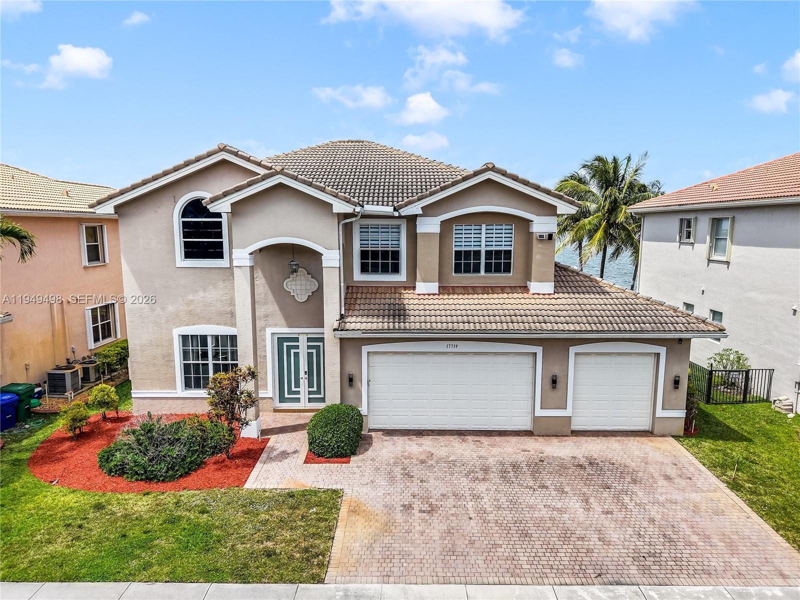 17739 Southwest 54th Street Miramar, FL 33029 - Photo 2 of 47 a front view of a house with a yard and potted plants