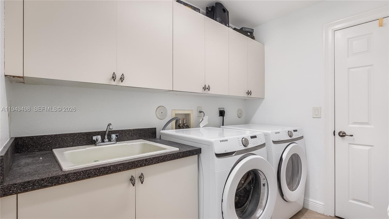 17739 Southwest 54th Street Miramar, FL 33029 - Photo 22 of 47 a utility room with sink dryer and washer