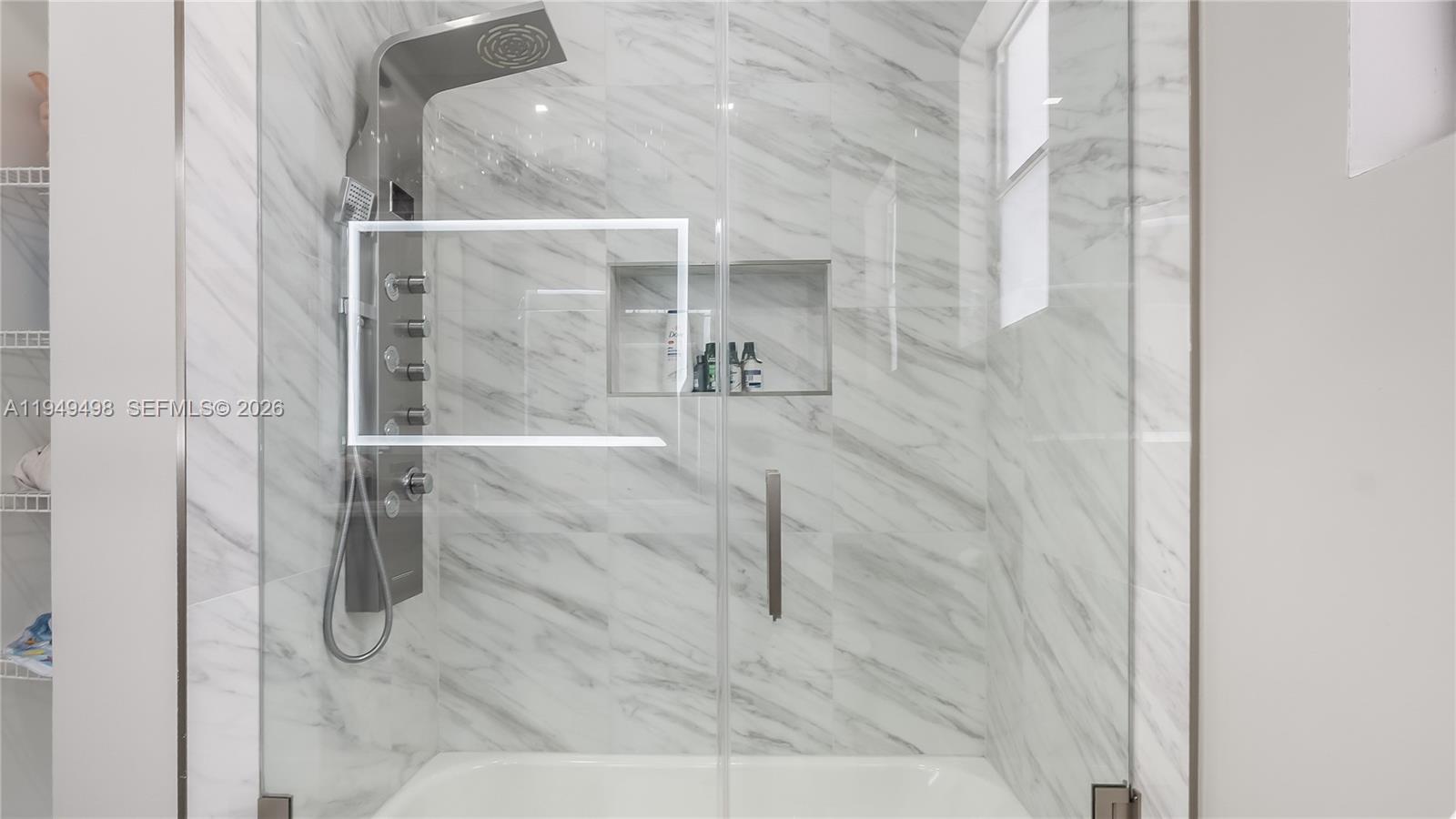 17739 Southwest 54th Street Miramar, FL 33029 - Photo 28 of 47 a bathroom with a glass shower door