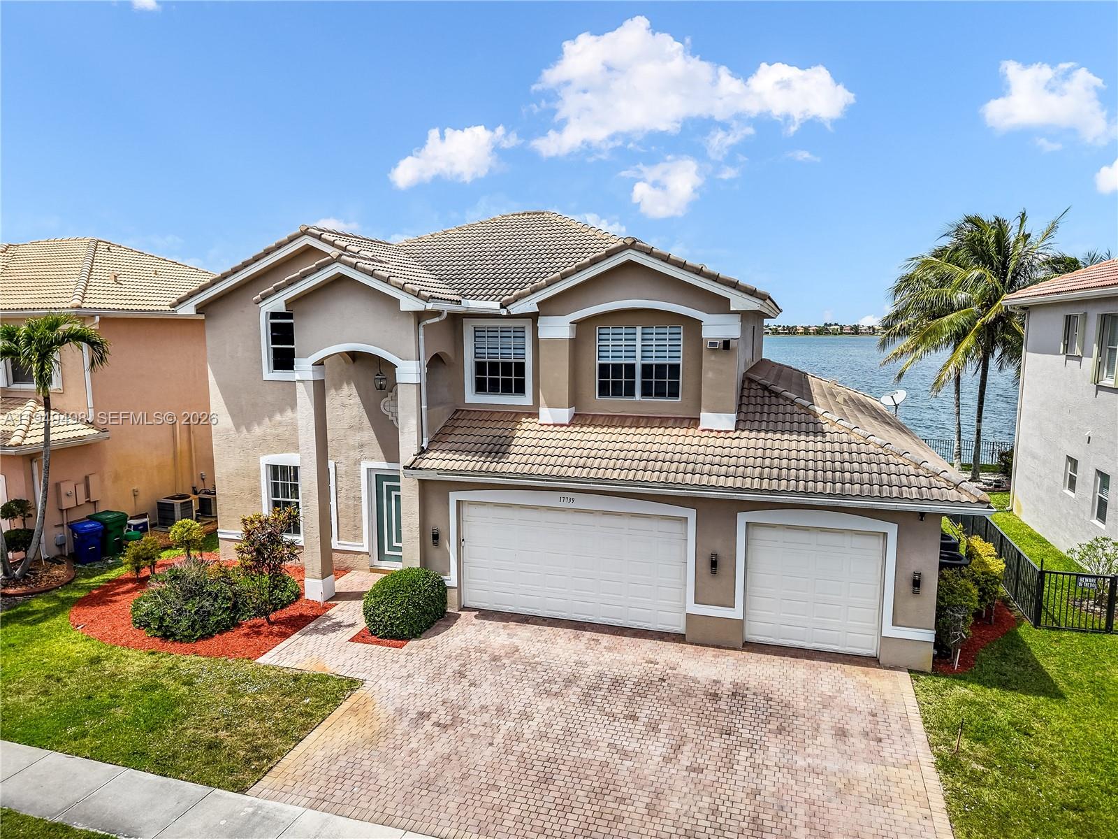 17739 Southwest 54th Street Miramar, FL 33029 - Photo 3 of 47 a front view of a house with a yard and garage