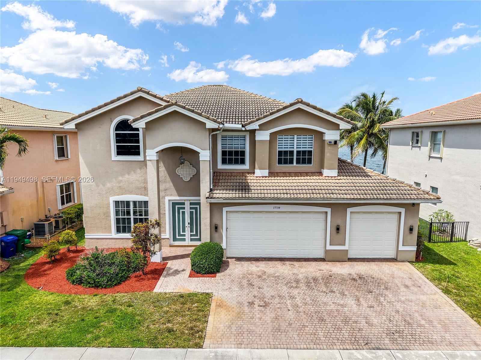 17739 Southwest 54th Street Miramar, FL 33029 - Photo 47 of 47 a front view of a house with a yard and garage