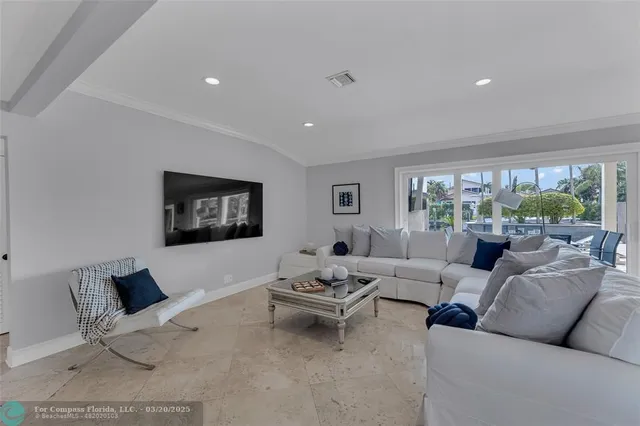 a living room with furniture a flat screen tv and a large window