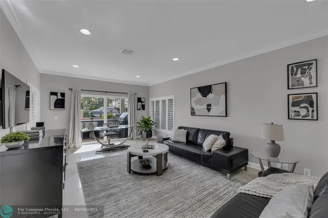 front view of a brick house with potted plants