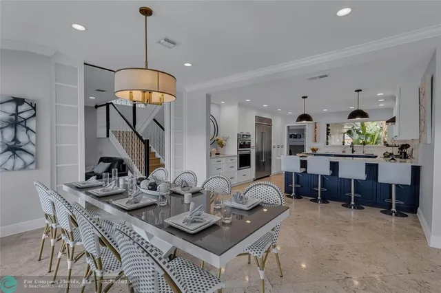 a swimming pool with outdoor seating and plants