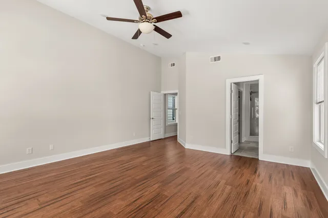 a bathroom with a granite countertop sink a toilet and a shower