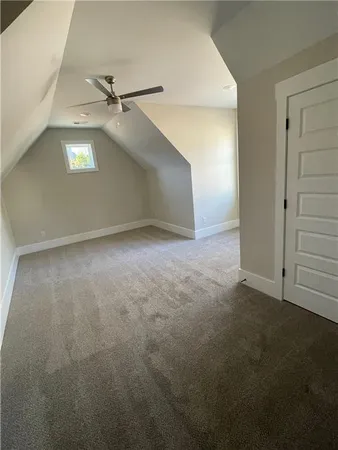 an empty room with a ceiling fan and a window
