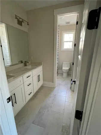 a bathroom with a double vanity sink and mirror
