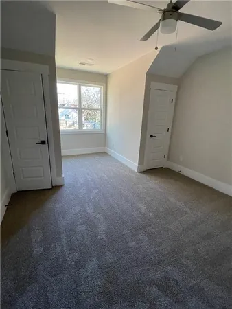 a view of a livingroom with window and bathroom