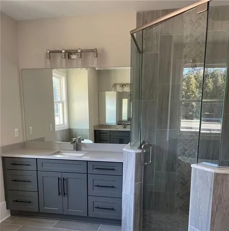 a bathroom with a double vanity sink and mirror
