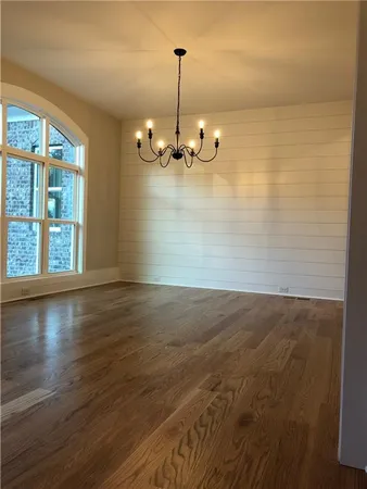 a view of a room with wooden floor