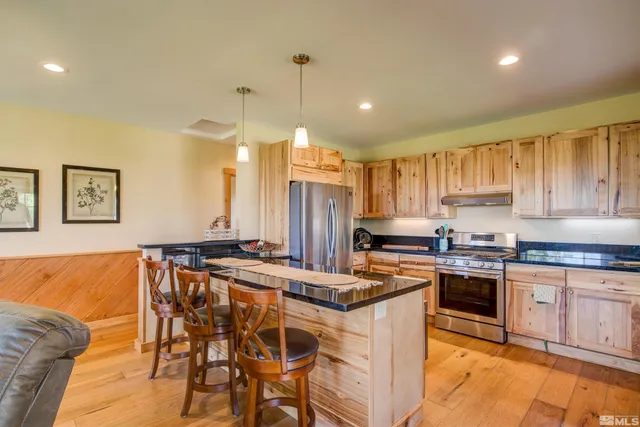 a kitchen with stainless steel appliances granite countertop a stove a sink dishwasher and a refrigerator