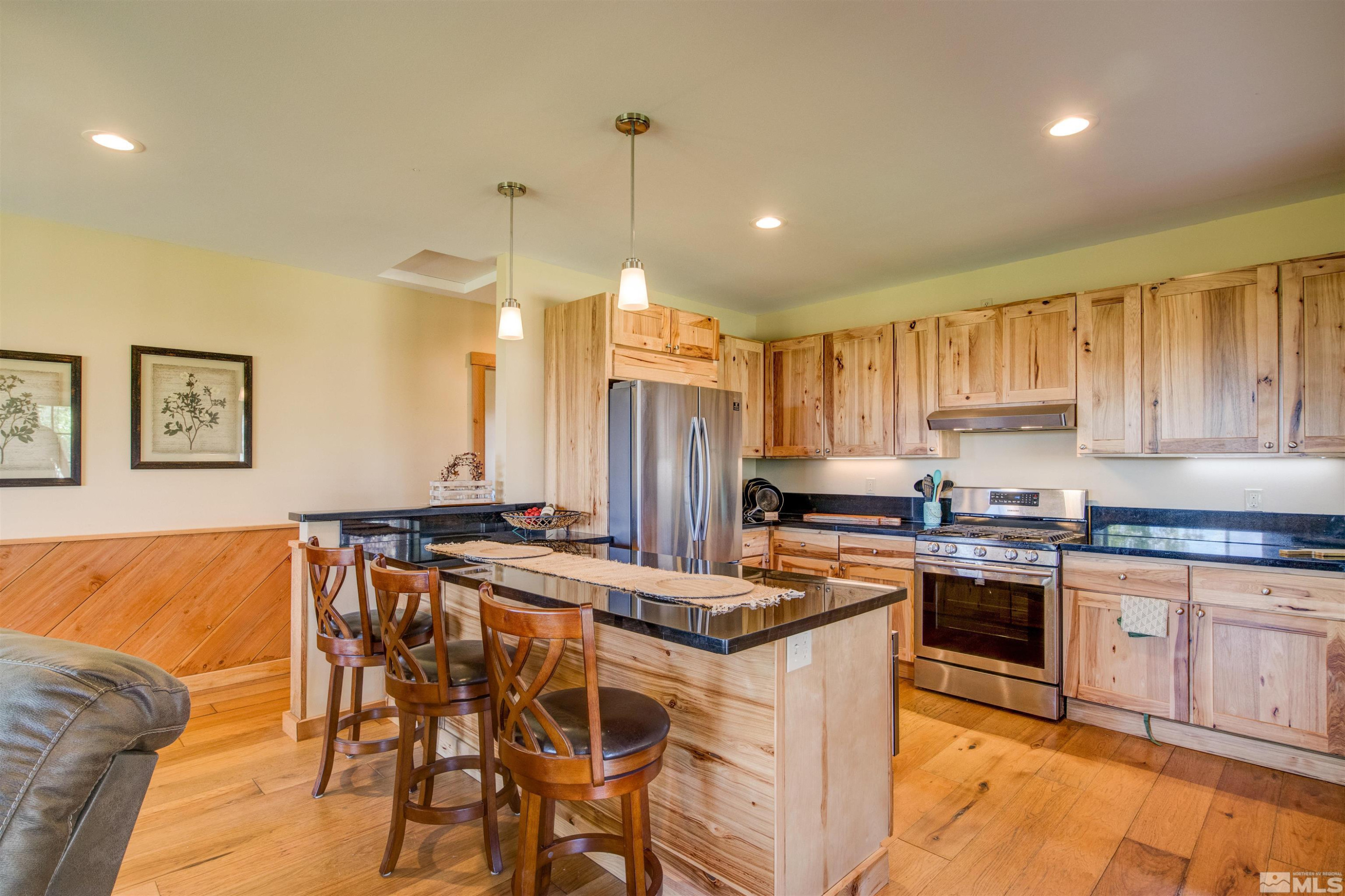 1461 Foothill Road Gardnerville, NV 89460 - Photo 12 of 39 a kitchen with stainless steel appliances granite countertop a stove a sink dishwasher and a refrigerator