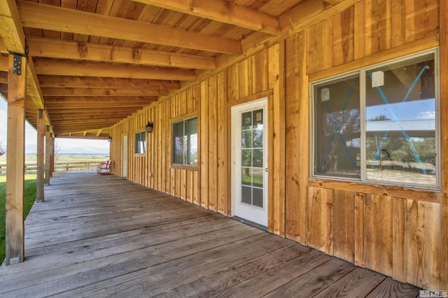 a view of a porch with wooden floor and stairs