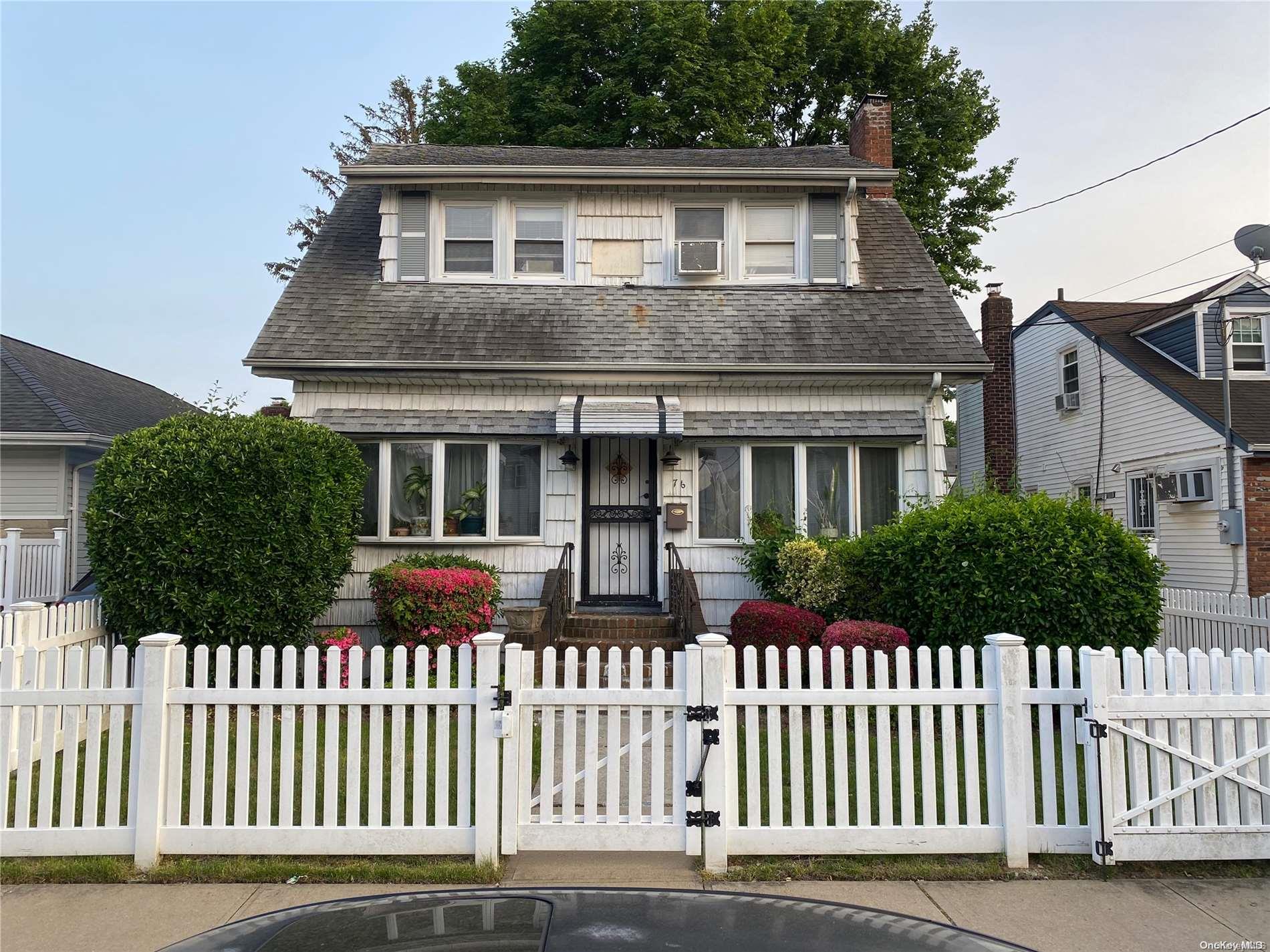 a front view of house with a garden