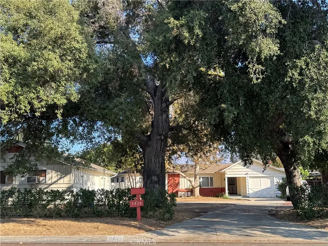 a white house with trees in front of it