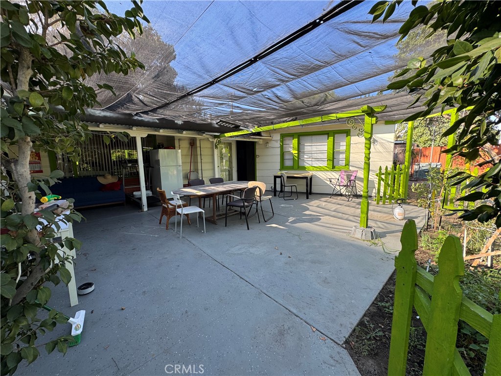 9409 Olive Street Temple City, CA 91780 - Photo 7 of 7 a view of a patio with table and chairs potted plants and large tree