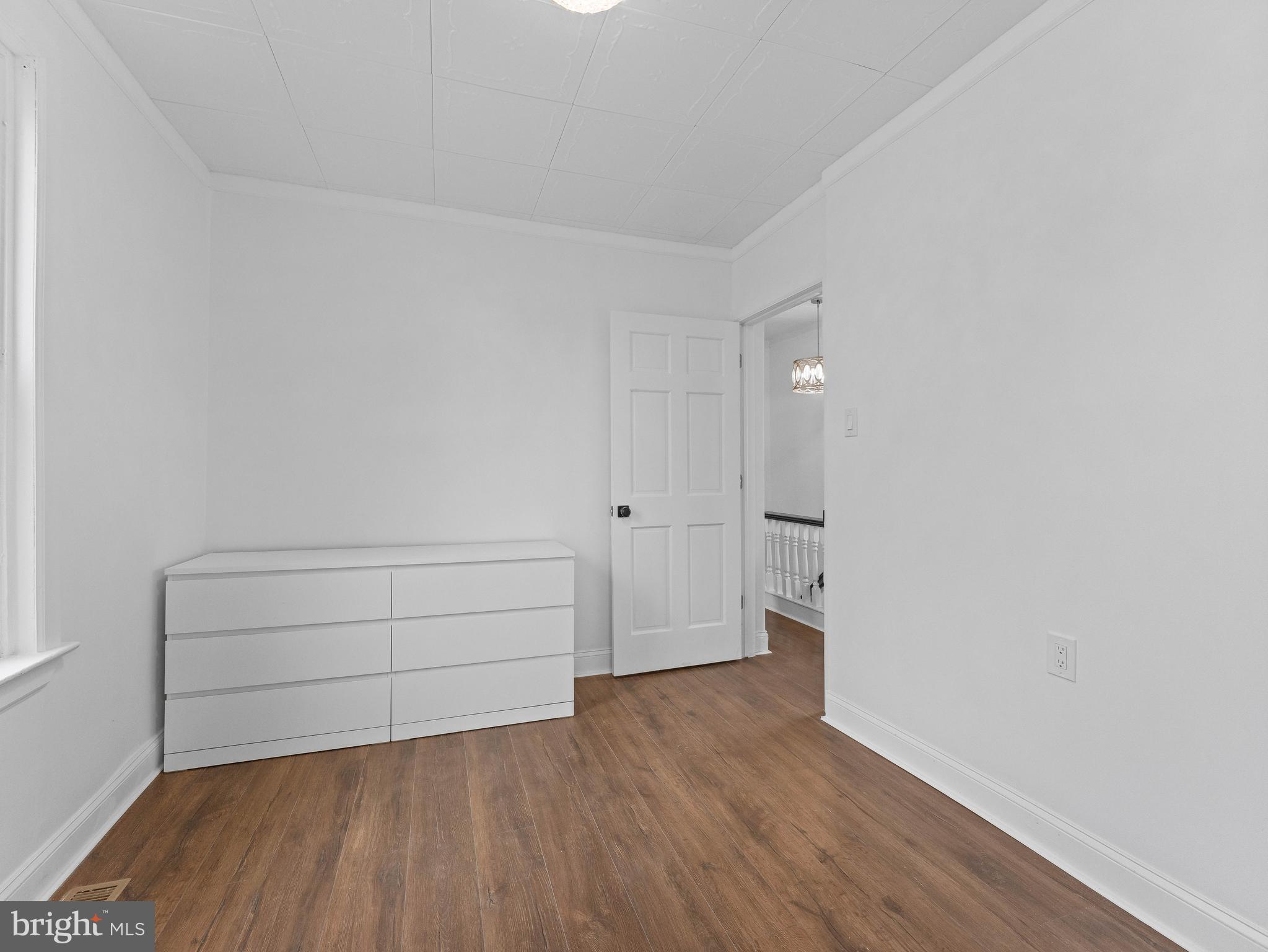 209 Upland Road Brookhaven, PA 19015 - Photo 27 of 39 a view of an empty room and wooden floor