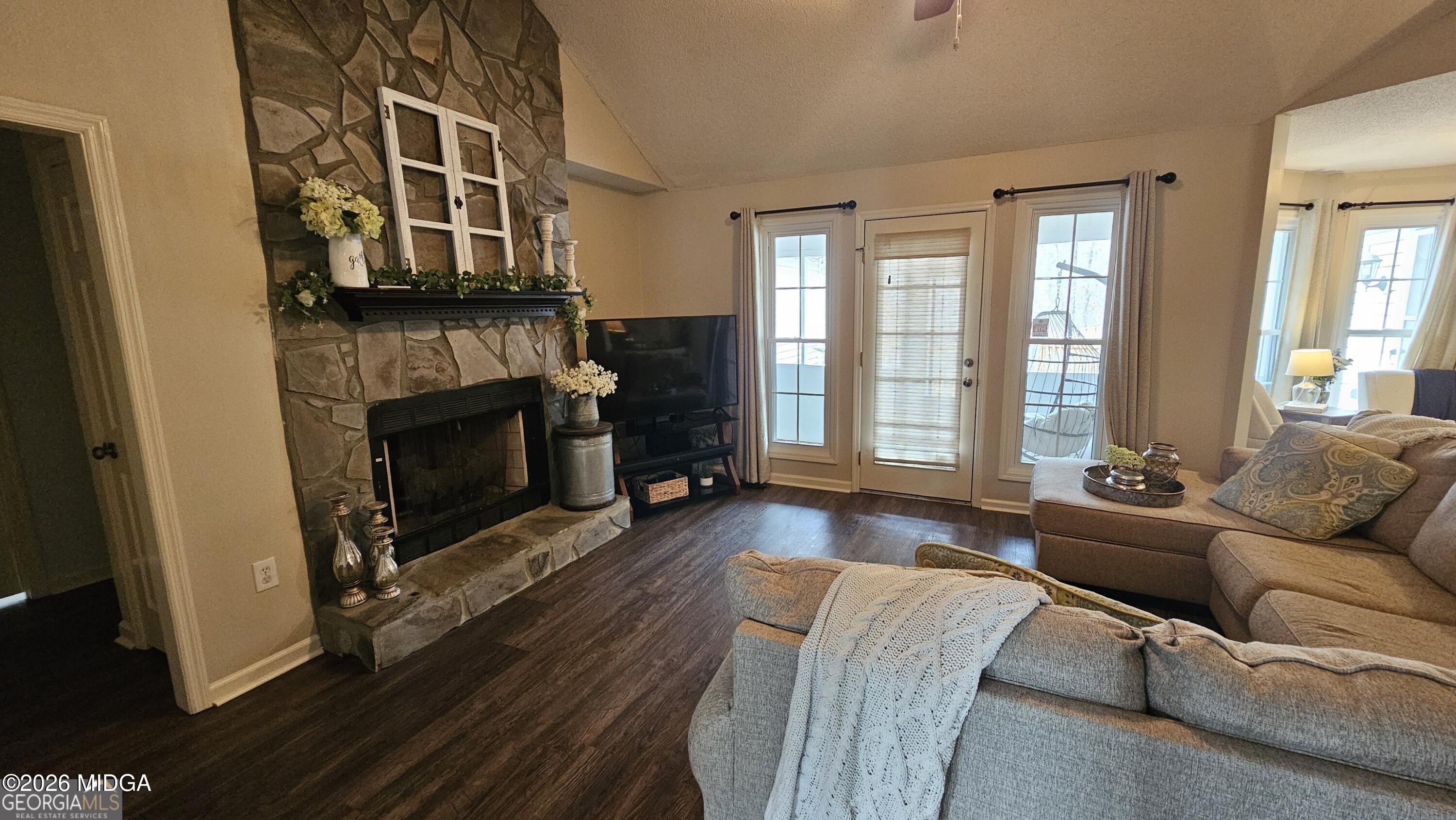 306 Lakeridge Court Macon, GA 31211 - Photo 3 of 14 a living room with furniture and a fireplace