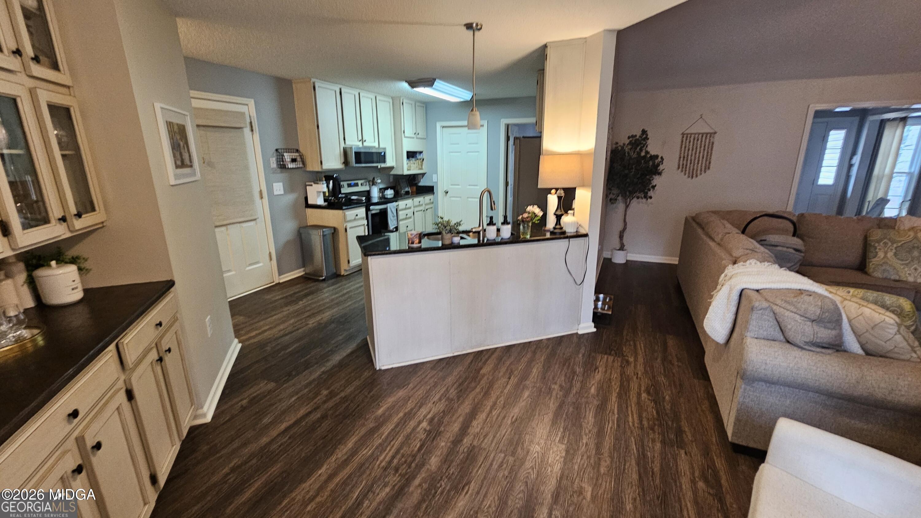 306 Lakeridge Court Macon, GA 31211 - Photo 10 of 14 a kitchen with stainless steel appliances granite countertop a refrigerator a sink dishwasher a stove and white countertops with wooden floor