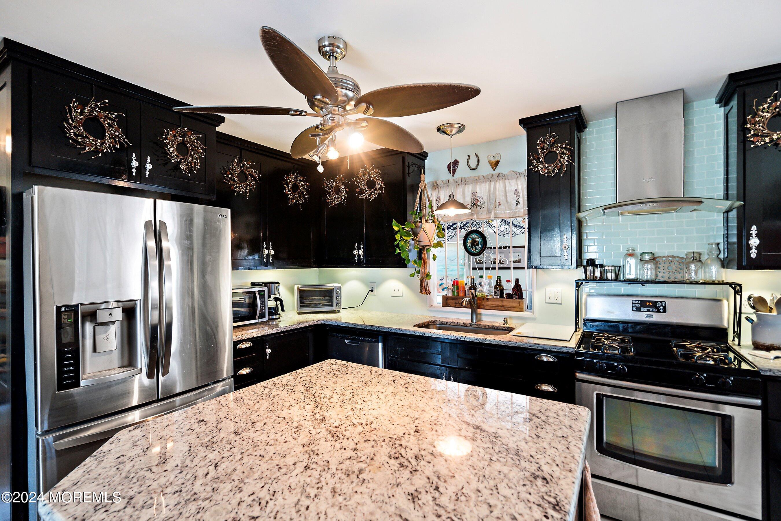 31 Cedar Run Road Bayville, NJ 08721 - Photo 12 of 34 a kitchen with stainless steel appliances kitchen island granite countertop a sink stove and refrigerator