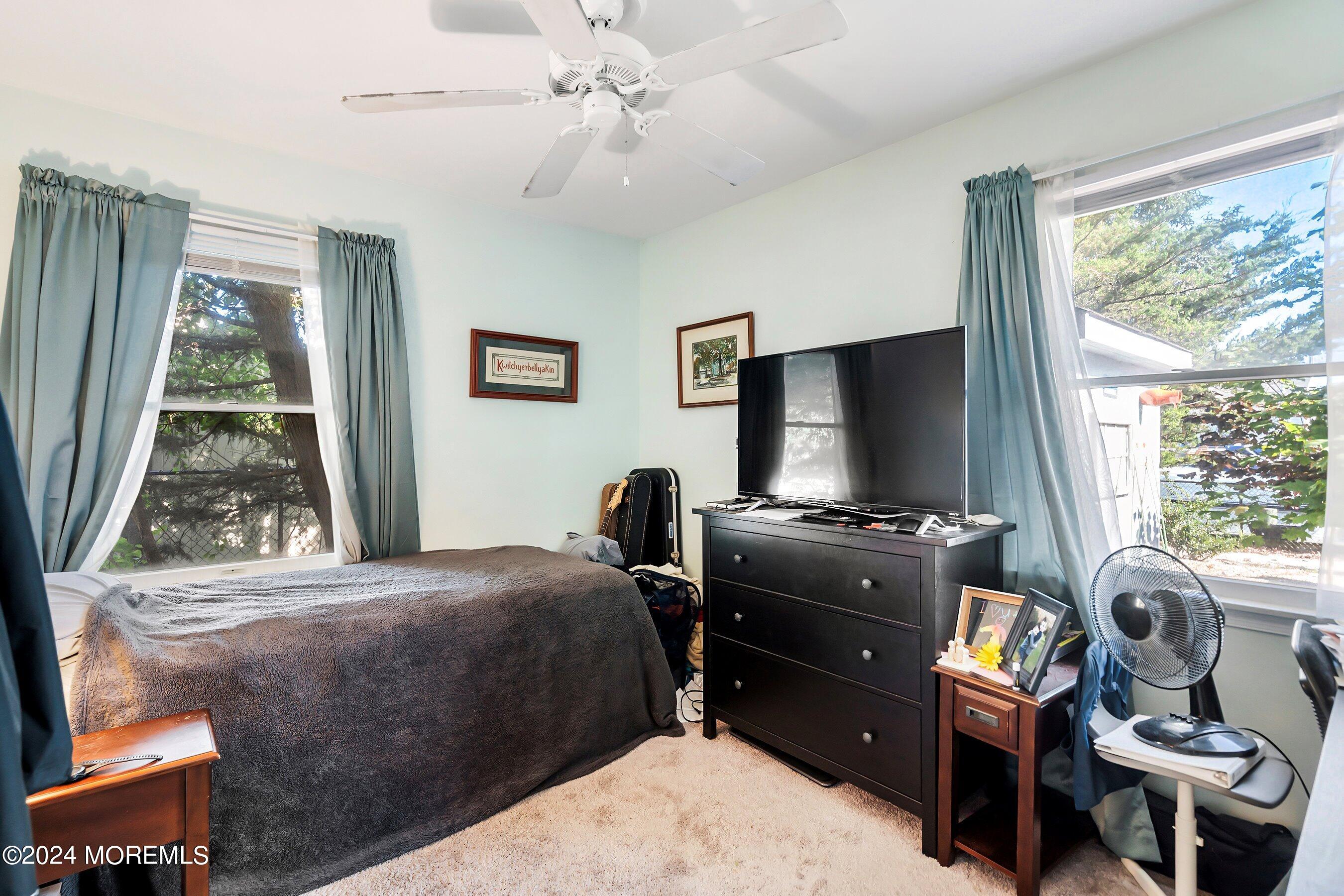 31 Cedar Run Road Bayville, NJ 08721 - Photo 18 of 34 a bedroom with a bed and a flat tv screen
