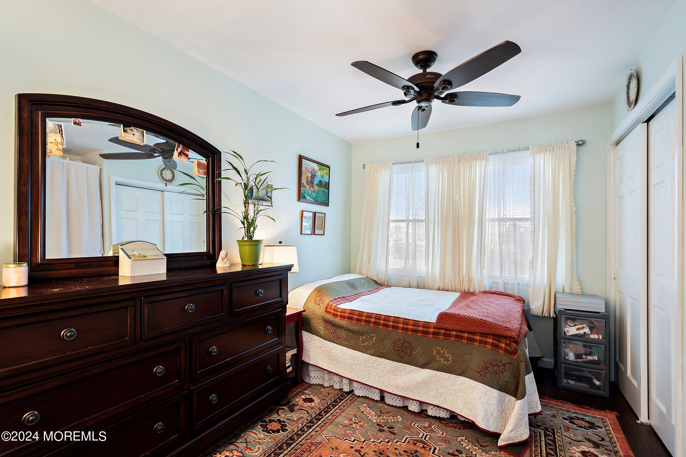 31 Cedar Run Road Bayville, NJ 08721 - Photo 20 of 34 a bedroom with a bed and a mirror on dresser