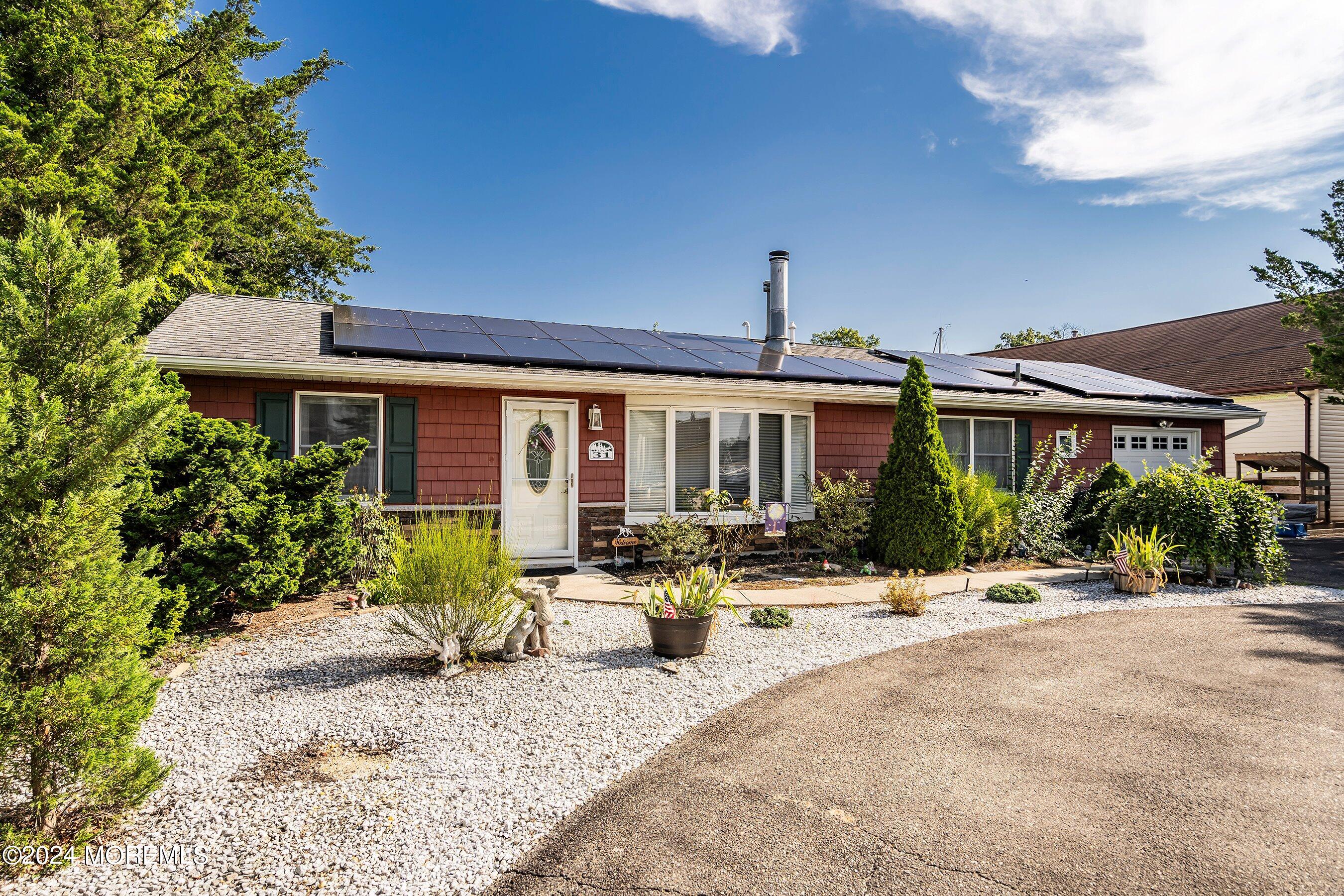 31 Cedar Run Road Bayville, NJ 08721 - Photo 6 of 34 a front view of a house with lots of green space