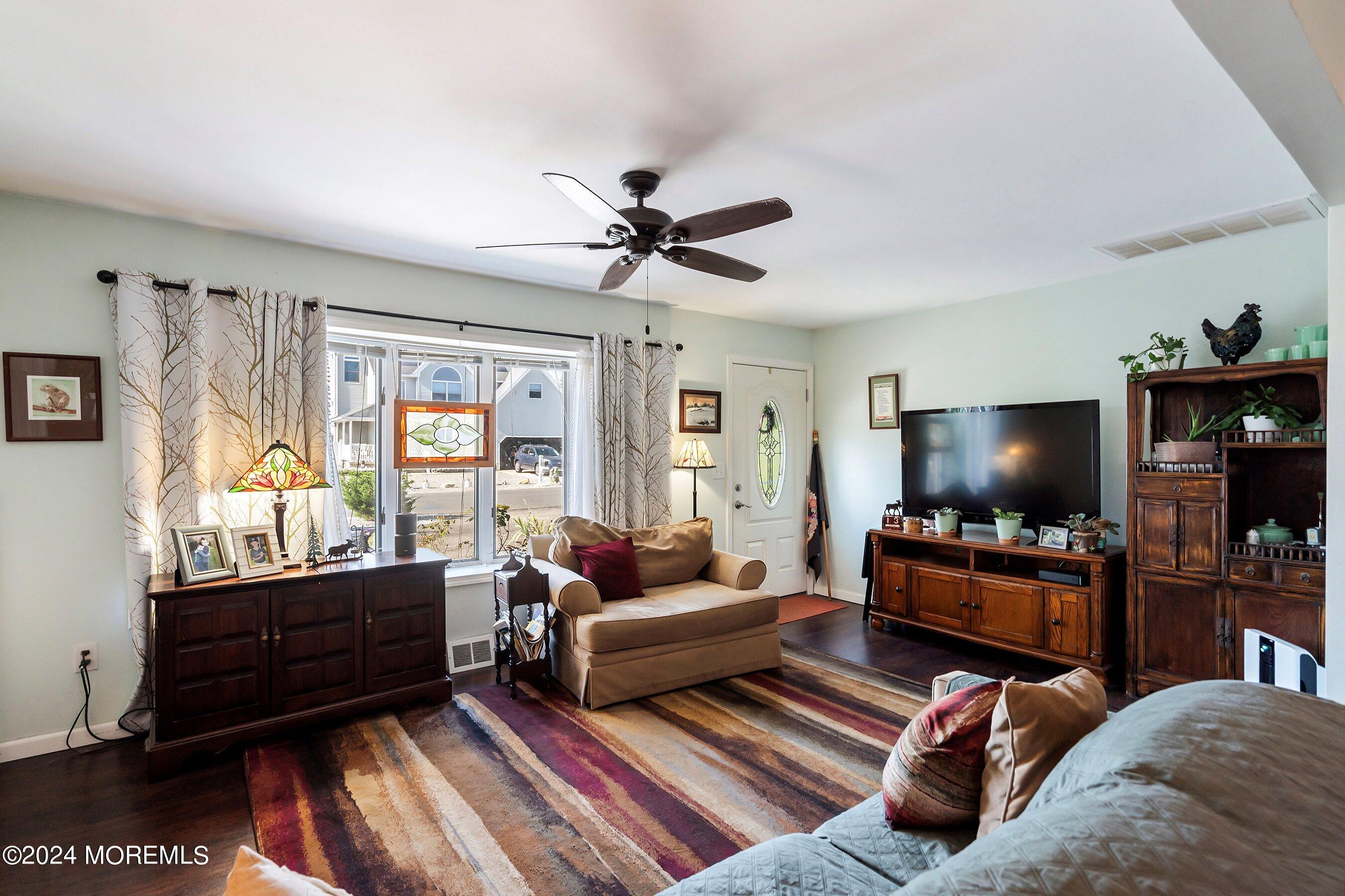31 Cedar Run Road Bayville, NJ 08721 - Photo 7 of 34 a living room with furniture and a flat screen tv