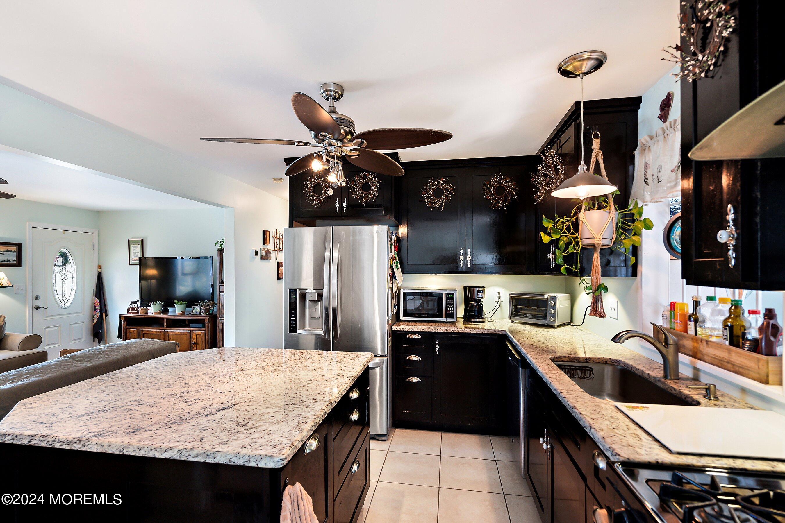 31 Cedar Run Road Bayville, NJ 08721 - Photo 10 of 34 a kitchen with stainless steel appliances granite countertop a sink stove and refrigerator