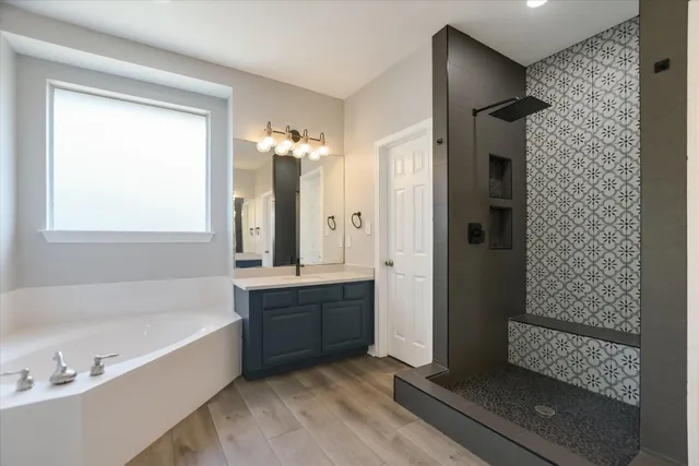 a bathroom with a tub shower and sink