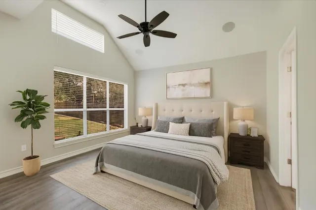 a bedroom with a large bed and a large window