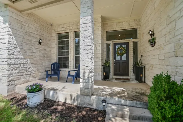 a front view of a house with outdoor seating and plants
