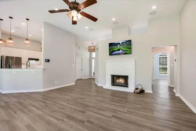 a view of a livingroom with a fireplace and window
