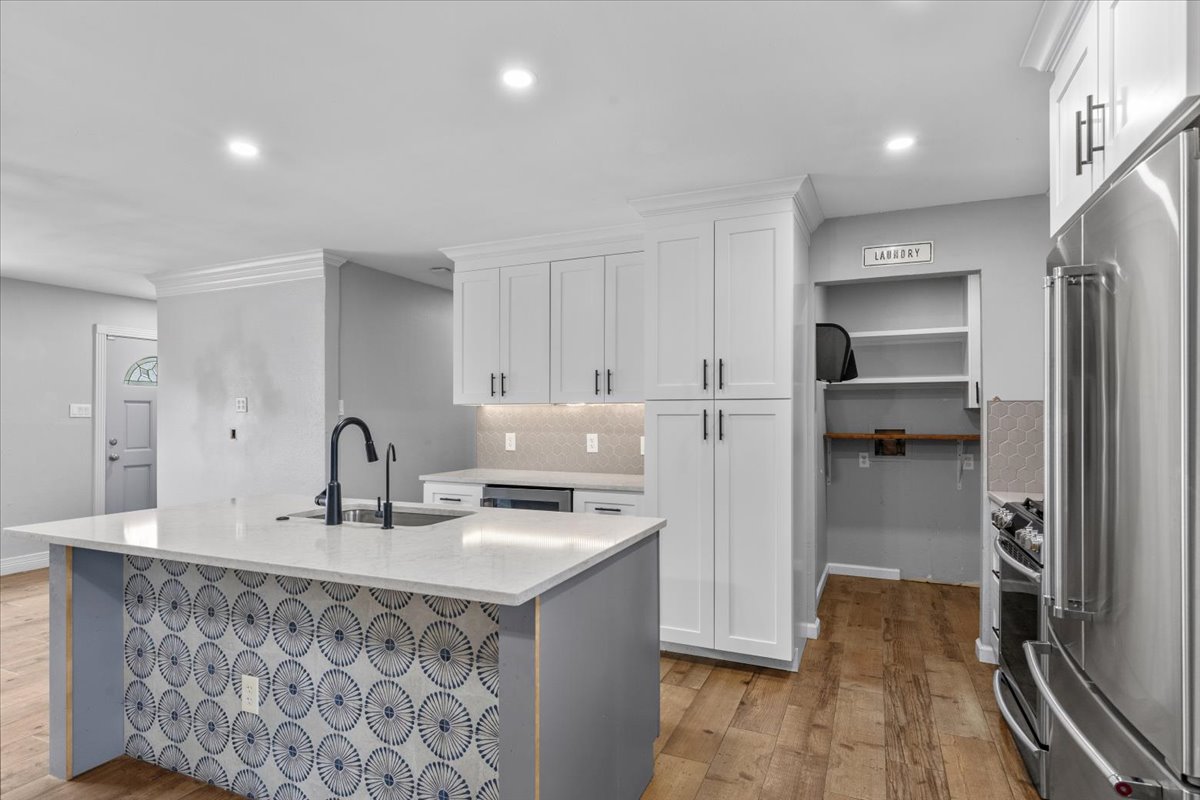 6200 Shadow Bend Austin, TX 78745 - Photo 12 of 33 A well-appointed kitchen features a stylish island with a patterned facade and modern stainless steel appliances.