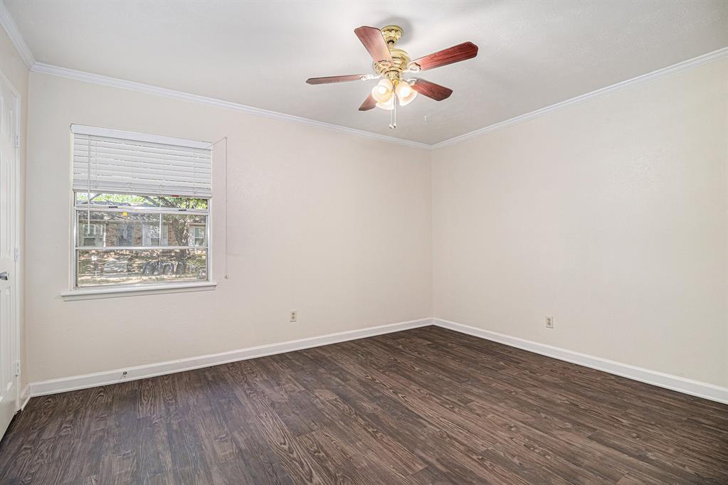 1814 Addington Drive Carrollton, TX 75007 - Photo 13 of 24 Empty room featuring crown molding, dark hardwood / wood-style flooring, and ceiling fan